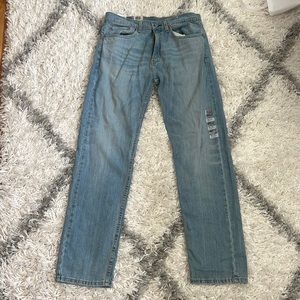Levi jeans, 505 regular stretch, sits at waist, extra room in thigh, straight.